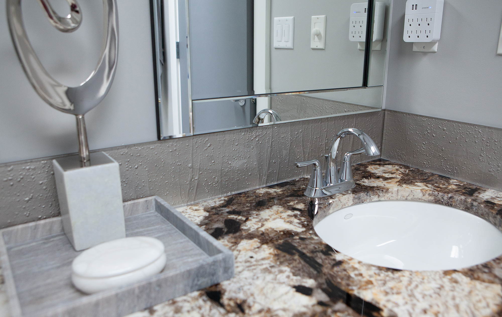 gray firemolded glass backsplash in a bathroom